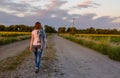 Woman walking down a country road Royalty Free Stock Photo