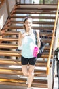 Woman walking down stairs Royalty Free Stock Photo