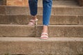 Woman walking down stairs wearing high heels. You can see her feet going down the steps Royalty Free Stock Photo