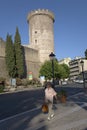 Woman walking down street in front of Tivoli Castle, or Castle of Rocca Pia, built in 1461 by Pope Pius II, Tivoli, Italy, Europe