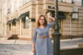 Woman walking in dress in old city. Fashion Style Photo Of A Young Girl. happy stylish woman at old european city street Royalty Free Stock Photo