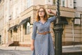 Woman walking in dress in old city. Fashion Style Photo Of A Young Girl. happy stylish woman at old european city street Royalty Free Stock Photo