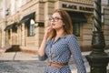 Woman walking in dress in old city. Fashion Style Photo Of A Young Girl. happy stylish woman at old european city street Royalty Free Stock Photo