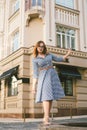 Woman walking in dress in old city. Fashion Style Photo Of A Young Girl. happy stylish woman at old european city street Royalty Free Stock Photo