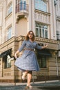 Woman walking in dress in old city. Fashion Style Photo Of A Young Girl. happy stylish woman at old european city street Royalty Free Stock Photo