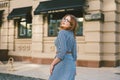 Woman walking in dress in old city. Fashion Style Photo Of A Young Girl. happy stylish woman at old european city street Royalty Free Stock Photo