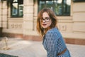 Woman walking in dress in old city. Fashion Style Photo Of A Young Girl. happy stylish woman at old european city street Royalty Free Stock Photo