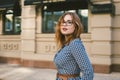 Woman walking in dress in old city. Fashion Style Photo Of A Young Girl. happy stylish woman at old european city street Royalty Free Stock Photo