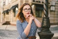 Woman walking in dress in old city. Fashion Style Photo Of A Young Girl. happy stylish woman at old european city street Royalty Free Stock Photo