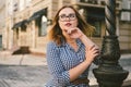 Woman walking in dress in old city. Fashion Style Photo Of A Young Girl. happy stylish woman at old european city street Royalty Free Stock Photo