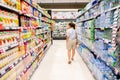 A woman is walking in drinkings shelves Royalty Free Stock Photo