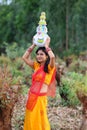 Woman walking with earthen pots Royalty Free Stock Photo