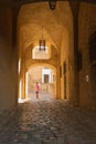 Woman walking through the entrance to the citadel in Calvi, Corsica Royalty Free Stock Photo