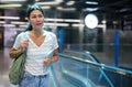 Woman walking beside escalator in subway station Royalty Free Stock Photo