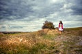 Woman walking on a field path