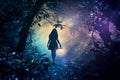 Woman Walking Through Forest Holding Lantern Royalty Free Stock Photo