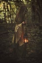 Woman walking in a forest with lantern Royalty Free Stock Photo