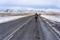 Woman walking on free road of adventure in Iceland winter time with snowy mountains Royalty Free Stock Photo