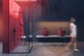 Woman walking in gray in red bathroom Royalty Free Stock Photo