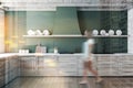 Woman walking in green kitchen with counters Royalty Free Stock Photo