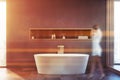 Woman walking in grey bathroom with tub Royalty Free Stock Photo