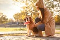 Woman walking her cute Beagle dog in autumn park Royalty Free Stock Photo