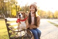 Woman walking her cute Beagle dog in autumn park Royalty Free Stock Photo