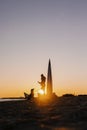 woman walking her dog at sunset, beautiful sunset against the background of modern buildings Royalty Free Stock Photo