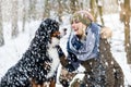 Woman walking her dog in the winter and both explore the snow together Royalty Free Stock Photo