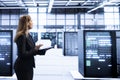 Woman walking in high tech facility, doing upgrades
