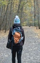 woman walking on a hiking trail in Taughannock Falls State Park with hat and backpack Royalty Free Stock Photo