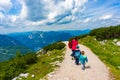 Woman walking with kids on a mountain footpath Royalty Free Stock Photo