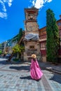 Woman walking at Leaning Clock Tower in Tbilisi, Georgia