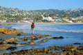 Woman walking on the Main Beach, Laguna Beach CA.