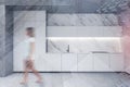 Woman walking in marble and concrete kitchen Royalty Free Stock Photo