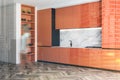 Woman walking in minimalist orange kitchen Royalty Free Stock Photo