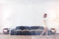Woman walking in minimalistic white living room Royalty Free Stock Photo