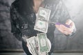 Woman walking money in US dollars as a symbol of bribery in politics, business, diplomacy