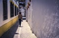 Woman walking in a narrow old street in Ronda, Andalusia, Spain. Royalty Free Stock Photo