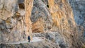 Woman walking through the narrow opening in the stone road in Kemaliye Egin town of Erzincan, Turkey