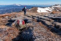 Woman walking next to path mark with Austrian flag painted on Saualpe, Carinthia, Austria. Morning hoarfrost Royalty Free Stock Photo