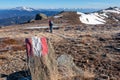 Woman walking next to path mark with Austrian flag painted on Saualpe, Carinthia, Austria. Morning hoarfrost Royalty Free Stock Photo