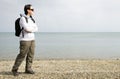 Woman walking next to the sea on pebble beach