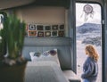 Woman walking outside her camper van. View from interior. Knit decorations inside. Concept of travel and rv motorhome vanlife