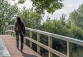 Woman walking over a simple wooden bridge Royalty Free Stock Photo