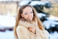 Woman is walking in park alley in winter