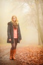 Woman walking in park in foggy day Royalty Free Stock Photo