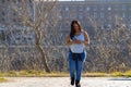 Woman walking in a park looking at her cell phone Royalty Free Stock Photo