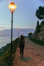 woman walking by park near sea on sunset Royalty Free Stock Photo
