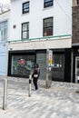 Woman Walking Past A Close High Street Retail Business Shop